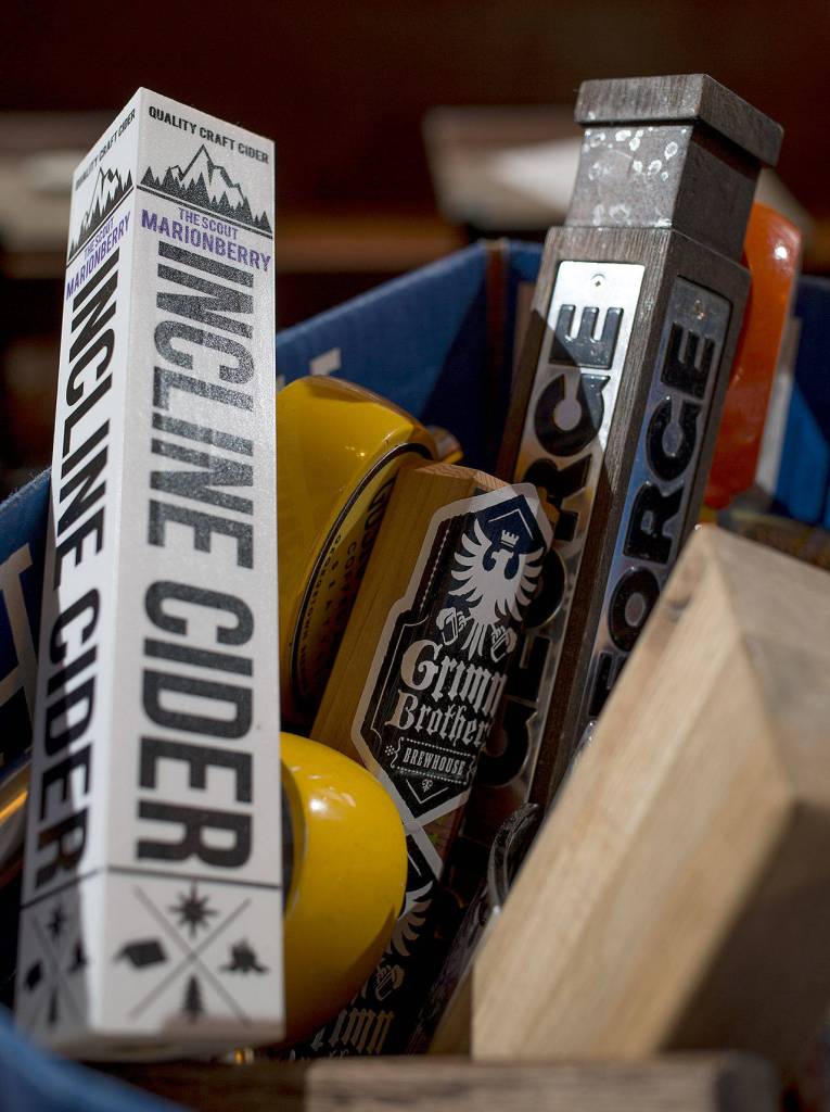 Beer tap handles in sit in alphabetical boxes at The Independent on Hewitt Avenue in Everett. (Andy Bronson / The Herald)