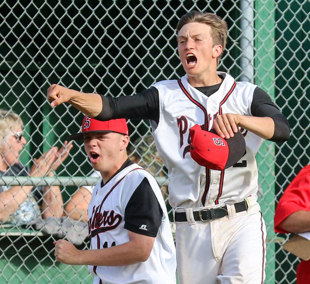 Snohomish&rsquo;s Cole McCalmon (left) and Kyle Sandifer celebrate a run in a winner-to-state, loser-out district game against Marysville Pilchuck on May 10, 2017, at Earl Torgeson Field in Snohomish. (Kevin Clark / The Herald)