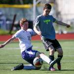 Kamiak&rsquo;s Dante Bianco attempts a slide tackle on Lake Stevens&rsquo; Jake Headland Saturday in a 4A District 1 tournament match in Mukilteo. Kamiak won 1-0. (Kevin Clark / The Herald)