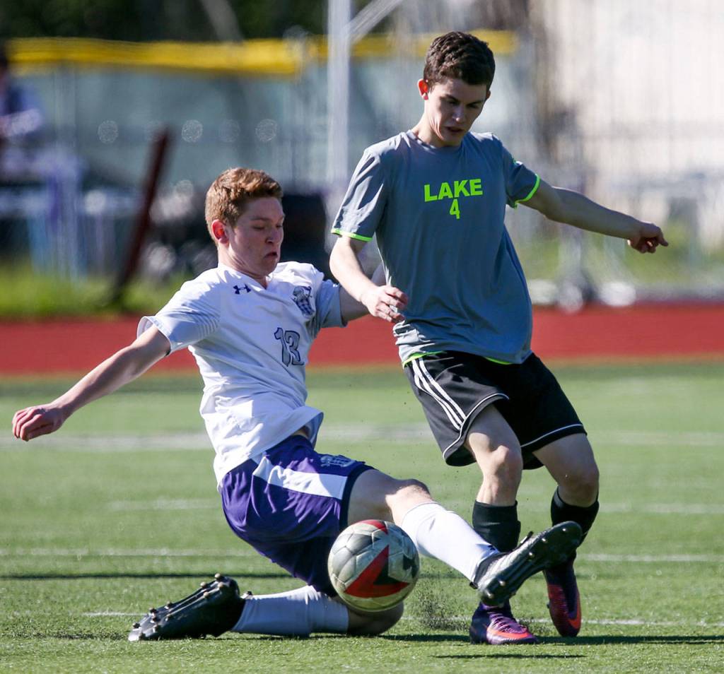 Kamiak&rsquo;s Dante Bianco attempts a slide tackle on Lake Stevens&rsquo; Jake Headland Saturday in a 4A District 1 tournament match in Mukilteo. Kamiak won 1-0. (Kevin Clark / The Herald)