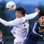Glacier Peak&rsquo;s Keegan Rubio (left) heads the ball with Mariner&rsquo;s Edgar Tavares challenging during the 4A District 1 title match on May 11, 2017, at Lake Stevens High School. (Kevin Clark / The Herald)