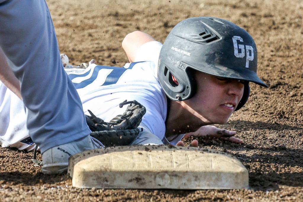 Glacier Peak&rsquo;s Riley Parker is tagged out at first base during a game against Monroe on May 3, 2017, at Glacier Peak High School in Snohomish. (Kevin Clark / The Herald)