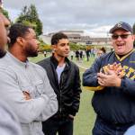 J Hopkins, Rendel Jones and Joe Giesick listen as Doug Hall (right) reminisces about the Everett&rsquo;s 2007 state championship run at Memorial Stadium in Everett on May 5, 2017. (Kevin Clark / The Herald)