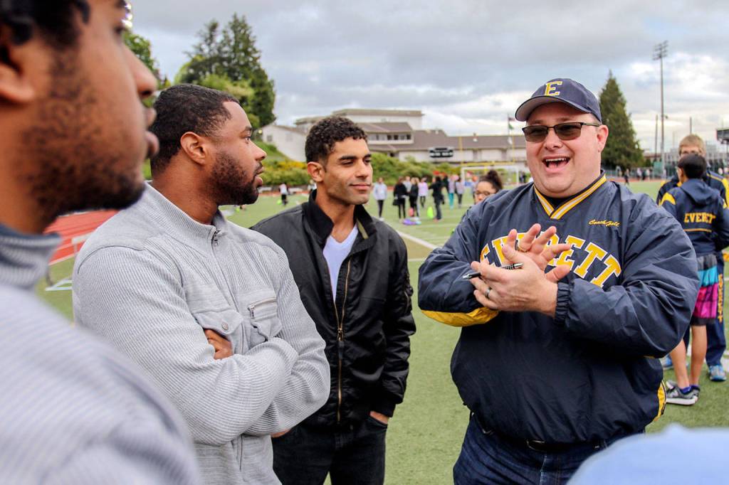 J Hopkins, Rendel Jones and Joe Giesick listen as Doug Hall (right) reminisces about the Everett&rsquo;s 2007 state championship run at Memorial Stadium in Everett on May 5, 2017. (Kevin Clark / The Herald)