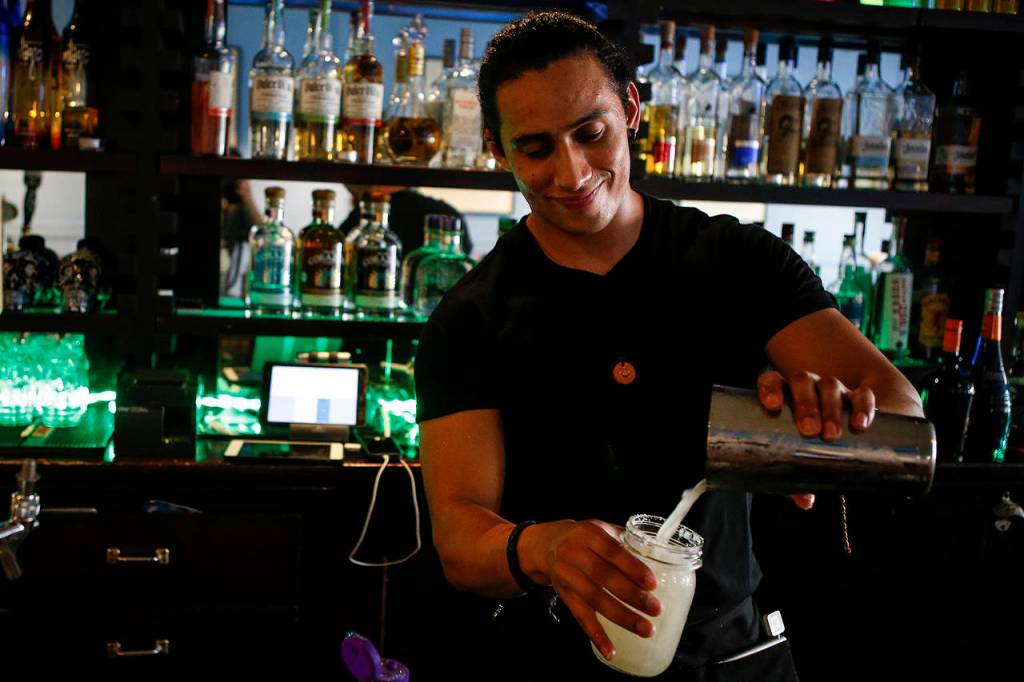 Bartender Christian Casanova serves up a margarita at Calle in downtown Mount Vernon. (Ian Terry / The Herald)