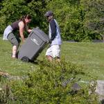 Adina Duke, left, and Rob Bolen work to haul yard waste from Little Cedars Elementary Saturday morning during the 3rd annual Day of Hope in Snohomish on May 20, 2017. Sponsored by Gold Creek Community Church, the two-day event drew nearly 1300 volunteers. (Kevin Clark / The Herald)