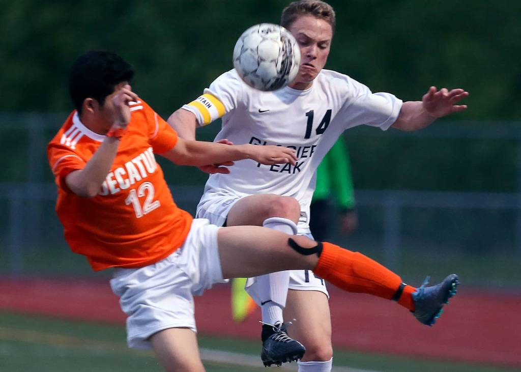 Decatur&rsquo;s Justin Cho (left) and Glacier Peak&rsquo;s Miles Johnston vie for control of the ball during a 4A state playoff game on May 17, 2017, at Glacier Peak High School in Snohomish. (Kevin Clark / The Herald)