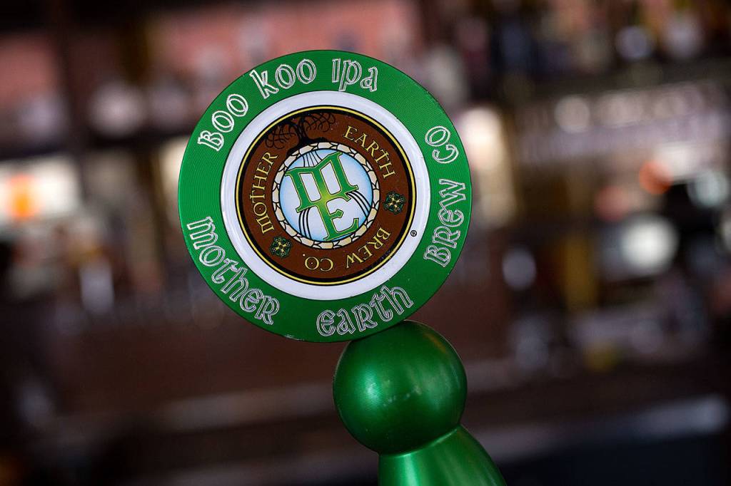 Beer tap handles come be made of all sorts of material including wood or metal like this one. Bothell&rsquo;s Decibel Brewing makes tap handles out of recycled microphones. (Andy Bronson / The Herald)