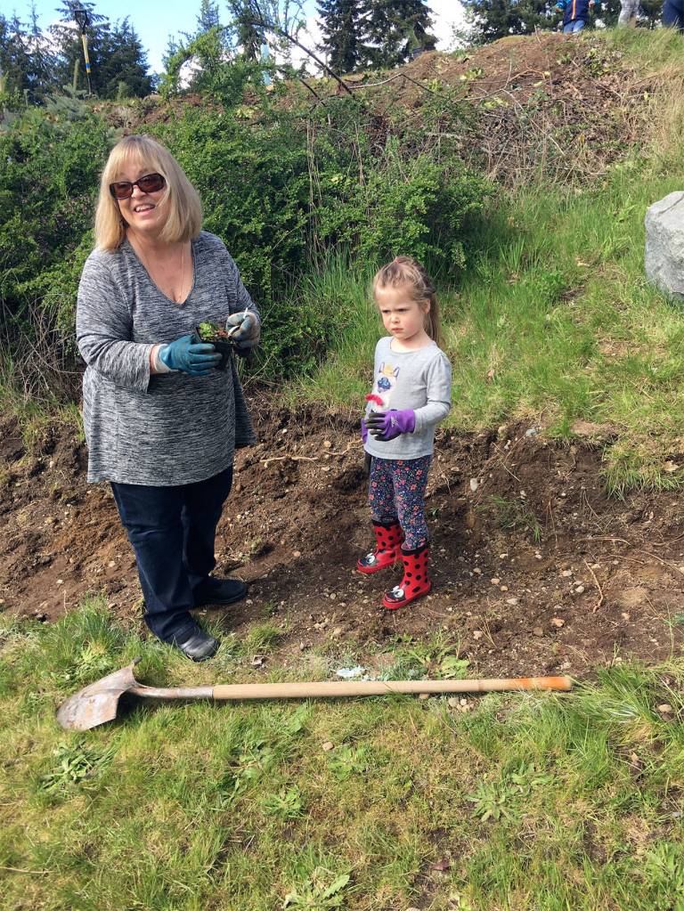 Teacher Patti Baughn and Amber Aleksich take part in a tree-planting event at Alderwood Early Childhood Center. (Contributed photo)