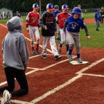 With helpers, including brother Noah right behind him, Jacob Irish steps onto home plate. With Noah are his Stilly Valley Little League Majors teammates Luke Ursino and Jackson Griffin. (Melanie Irish photo)