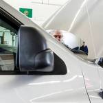 Gabe Lambert (center right) and Chad Avery (right), of Avery Automotive in Sultan, examine a used truck along with other dealers at Kaman Auctions in Edmonds. (Ian Terry / The Herald)