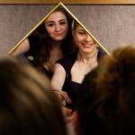 IzSabella Haviland (left) and Tetyana Popach, both 17, try on prom dresses together and share a small mirror Thursday morning, the day before Crossroads High School&rsquo;s first-ever prom night. (Dan Bates / The Herald)