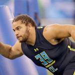 David J. Phillip / Associated Press                                Washington defensive lineman Elijah Qualls runs through a drill at the NFL scouting combine in March in Indianapolis. Qualls was drafted by the Philadelphia Eagles in the sixth round.