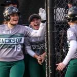 Jackson&rsquo;s Kassidi Dean (left) celebrates a run scored by Sam Klotter at Phil Johnson Ballfields in Everett on May 18. (Kevin Clark / The Herald)