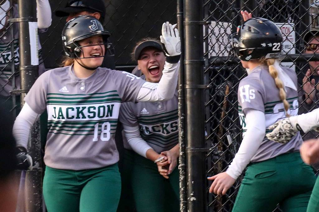 Jackson&rsquo;s Kassidi Dean (left) celebrates a run scored by Sam Klotter at Phil Johnson Ballfields in Everett on May 18. (Kevin Clark / The Herald)