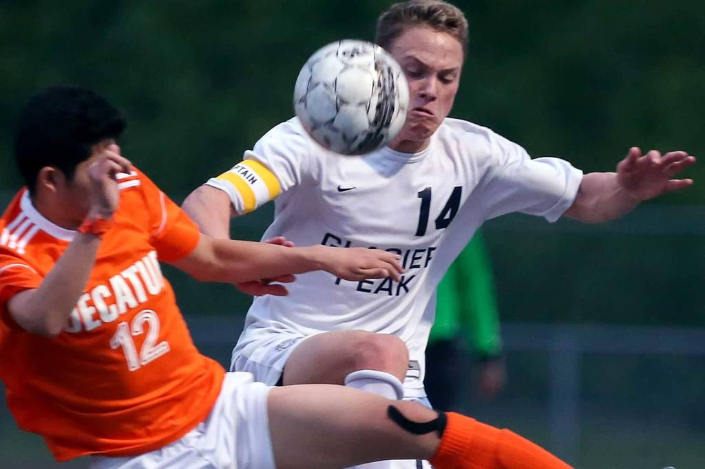 Decatur&rsquo;s Justin Cho (left) and Glacier Peak&rsquo;s Miles Johnston vie for control of the ball at Glacier Peak High School in Snohomish on May 17. (Kevin Clark / The Herald)