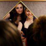 IzSabella Haviland (left) and Tetyana Popach, both 17, share a mirror as they try on dresses May 18 in anticipation of Crossroads High School&rsquo;s first-ever prom. (Dan Bates / The Herald)