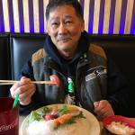 Glen Watanabe, of Lake Stevens, tries a piece of tuna sashimi at Kai Sushi in Everett. (Ben Watanabe / The Herald)