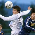 Glacier Peak&rsquo;s Keegan Rubio heads the ball with Mariner&rsquo;s Edgar Tavares challenging at Lake Stevens High School on April 11. (Kevin Clark / The Herald)