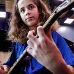 Elijah Croyle practices a short while on an electric guitar before joining the bassoon section and the rest of the band practicing Wednesday last week at Valley View Middle School in Snohomish. (Dan Bates / The Herald)