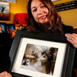 Mayume Carelli&rsquo;s home is filled with images of the people she loves, including the one she is holding of her dad, Dan Varnell at his favorite fishing hole on the Pilchuck River. It is where he was murdered by Gail Brashear in 1996. (Dan Bates / The Herald)