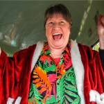 A delighted Sue Cheffer climbs into the driver&rsquo;s seat of a vintage Crown Motor Coach school bus when fellow drivers at Everett School District&rsquo;s bus barn at 37th and Oakes surprised her with a party and a ride Wednesday, just two days before her retirement. (Dan Bates / The Herald)