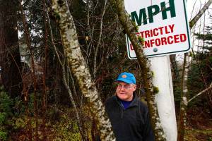 Dick Todd put up a sign trying to slow down traffic along 99th Ave SE in Lake Stevens where it borders his eight acres, but officials took it down. Now he has it wedged between some trees back off the city&rsquo;s right-of-way. Todd is very concerned about the high density housing going up to accommodate growth in the previously rural area. (Dan Bates / The Herald)