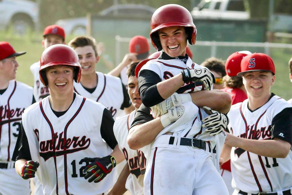 Snohomish&rsquo;s Chase Taylor is lifted by teammate Josh Johnston leading the celebration of their 5-4 win over Marysville Pilchuck at Earl Torgeson Field in Snohomish on May 10. (Kevin Clark / The Herald)