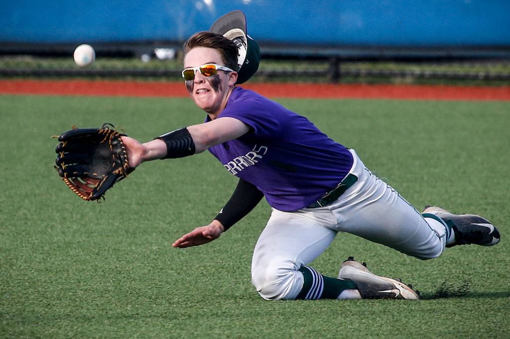 Edmonds-Woodway center fielder Ian Michael makes a diving catch to prevent a scoring run in extra innings during a Class 3A District 1 semifinal game against Snohomish on May 9 at Meridian Park Fields. (Ian Terry / The Herald)