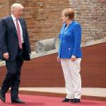 President Donald Trump and German Chancellor Angela Merkel arrive for a photo with G7 leaders at the Ancient Greek Theater on Friday in Taormina, Italy. (AP Photo/Evan Vucci)