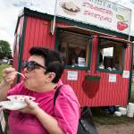 Anita Hills, of Mount Vernon, takes a bite of strawberry shortcake from Crystal Masonic Lodge&rsquo;s booth at the Marysville Strawberry Festival on June 16. (Ian Terry / The Herald)