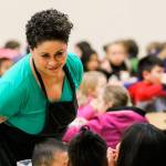 Lisa Gaines, the Nutrition Services lead at Challenger Elementary School in Everett, walks the aisles and talks to students during lunch earlier this year in February. (Kevin Clark / Herald file photo)