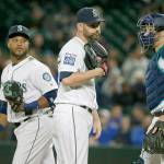 Seattle&rsquo;s Marc Rzepczynski (center) talks with Robinson Cano (left) and Mike Zunino (right) during the eighth inning of the Mariners&rsquo; 2-1 loss to the Twins on Thursday in Seattle. Cano committed two errors on one play that led to Minnesota&rsquo;s go-ahead run. (AP Photo/Ted S. Warren)