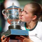 Jelena Ostapenko kisses the trophy after beating Simona Halep in three sets to win the women&rsquo;s French Open singles title Saturday in Paris. Ostapenko is the first unseeded player to win at Roland Garros since 1933 and the first Latvian to win a major. (AP Photo/Christophe Ena)