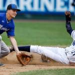 Aquasox runner Osmy Gregorio (right) slides safely into second base as Merchants second baseman Kevin Olmstead watches the ball during the Everett Cup exhibition game on June 13, 2017, at Everett Memorial Stadium. (Ian Terry / The Herald)
