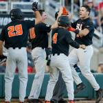 Oregon State&rsquo;s KJ Harrison (right) celebrates his grand slam with Steven Kwan (4), Michael Gretler (10) and Jack Anderson (29) in the sixth inning of Monday&rsquo;s College World Series game in Omaha, Nebraska. (AP Photo/Nati Harnik)