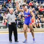 Simon Fraser University wrestler Morgan Smith raises his hand in victory a November match in Burnaby, British Columbia. (Simon Fraser University athletics)