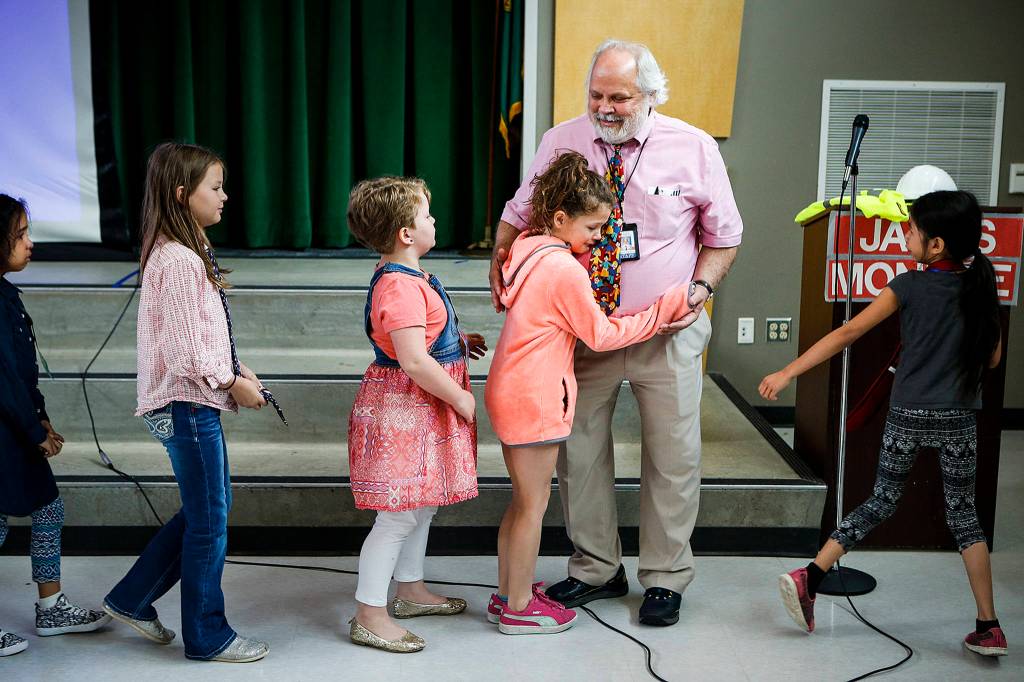 James Monroe Elementary School students say their goodbyes to Principal Gerard Holzman during an assembly to celebrate his 17 years of service at the Everett school on June 21. (Ian Terry / The Herald)