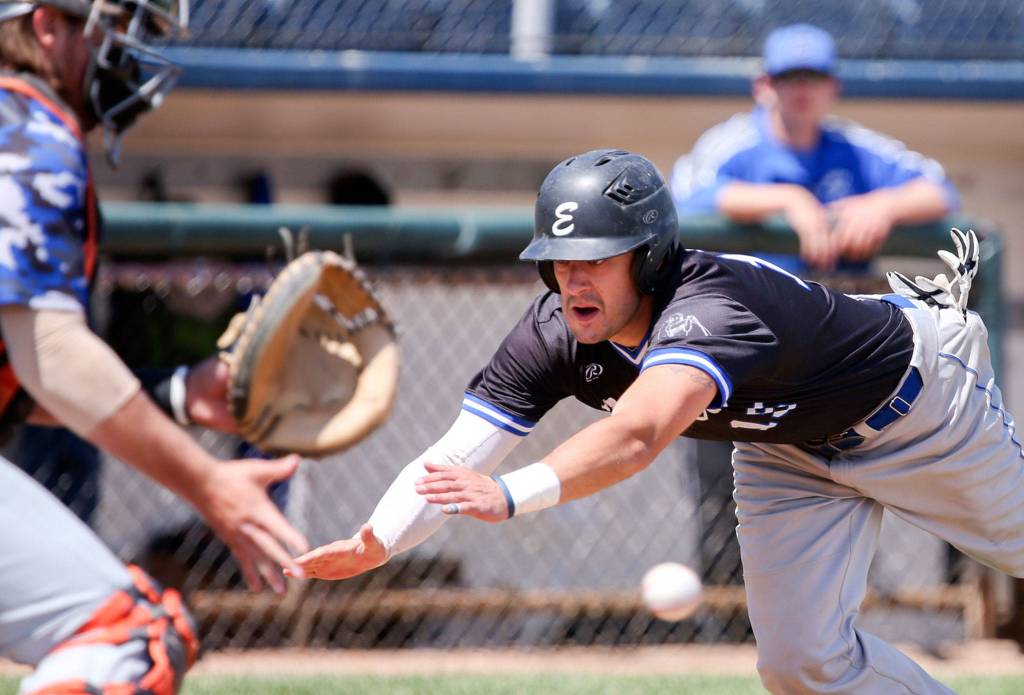 Matt Whitt beats the tag attempt by Kitsap&rsquo;s Nash Gowin at Everett Memorial Stadium in Everett on June 4. (Kevin Clark / The Herald)