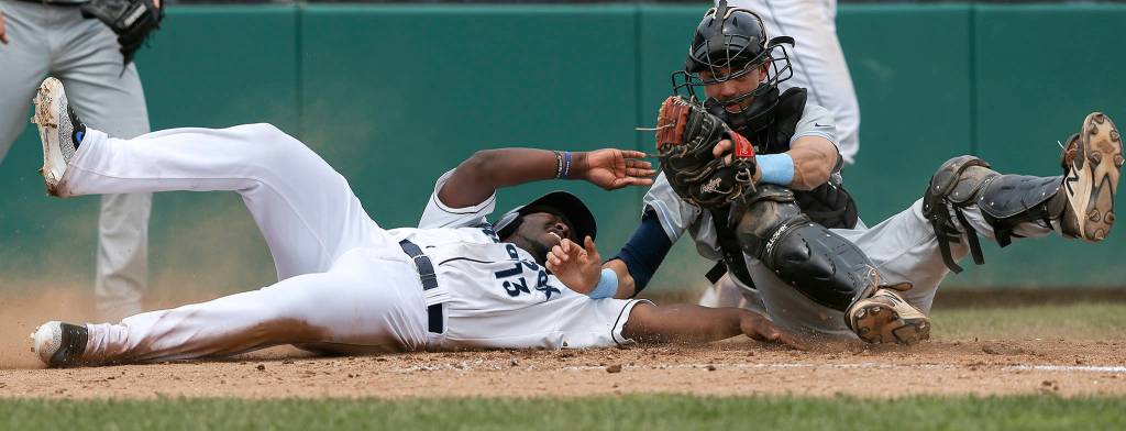 Aquasox&rsquo;s Greifer Andrade is tagged out at home plate by Hillsboro Hops catcher Cole Thompson in Everett&rsquo;s 9-2 loss to the Hops at Everett Memorial Stadium on June 19. (Andy Bronson / The Herald)