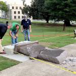 Personnel from the Secretary of State&rsquo;s office inspect the damage to the new Ten Commandments monument outside the state Capitol in Little Rock, Arkansas, on Wednesday. (AP Photo/Jill Zeman Bleed)