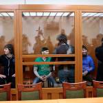 Defendants in the killing of Russian opposition leader Boris Nemtsov in a glass enclosure during their trial in a Moscow military district court on Tuesday. (AP Photo/Denis Tyrin)