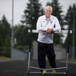 Duane Lewis poses on the Lynnwood High School track Monday. Lewis has retired after 45 years as the Royals&rsquo; head track and field coach. (Andy Bronson / The Herald)