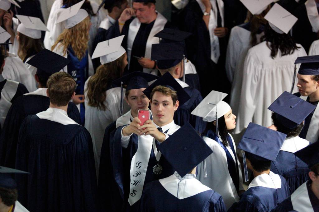 Glacier Peak High School seniors pose for a photo before their graduation ceremony at Xfinity Arena on Monday in Everett. (Andy Bronson / The Herald)