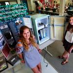 Lake Stevens High School seniors Isabelle Eelnurme (left) and Elise Gooding converted an old refrigerator to a hydroponic garden for their engineering design class. Their award-winning device is for growing healthy, nutritious produce in food deserts. (Dan Bates / The Herald)