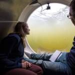 Bonnie Carl (left) and Josh Dean look out the dome as the OceanGate submarine Cyclops I submerges in the Port of Everett Marina recently. OceanGate plans to carry paying customers on dives to the RMS Titanic in 2018. (Andy Bronson / The Herald)