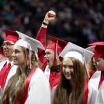 A Snohomish graduate cheers after the school alma mater song is played at the end of the graduation ceremony at Xfinity Arena on Monday in Everett. (Andy Bronson / The Herald)