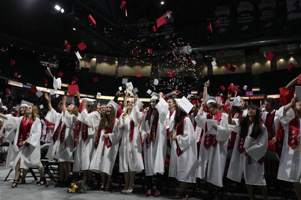Snohomish High graduates celebrate the end of their graduation ceremony at Xfinity Arena on Monday in Everett. (Andy Bronson / The Herald)