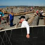 Paddle board instructor Doc Doolittle, of Seattle, carries his board down to the water at Marina Beach Park in Edmonds. &ldquo;This is a great sport for any age,&rdquo; Doolittle said. (Ian Terry / The Herald)