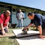 Machinist union members Steve Morrison (left), of Marysville, and Mike Hill, of Stanwood, work to install a wheelchair ramp at a home in Marysville on Saturday, May 27. (Ian Terry / The Herald)